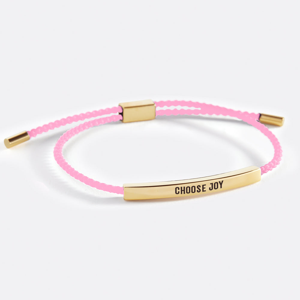 A bracelet with the text 'choose joy' printed on it, displayed on a white background.