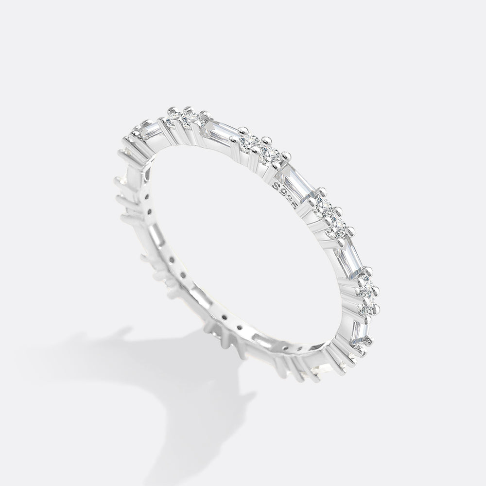 Silver ring with baguette-cut diamonds on a white background