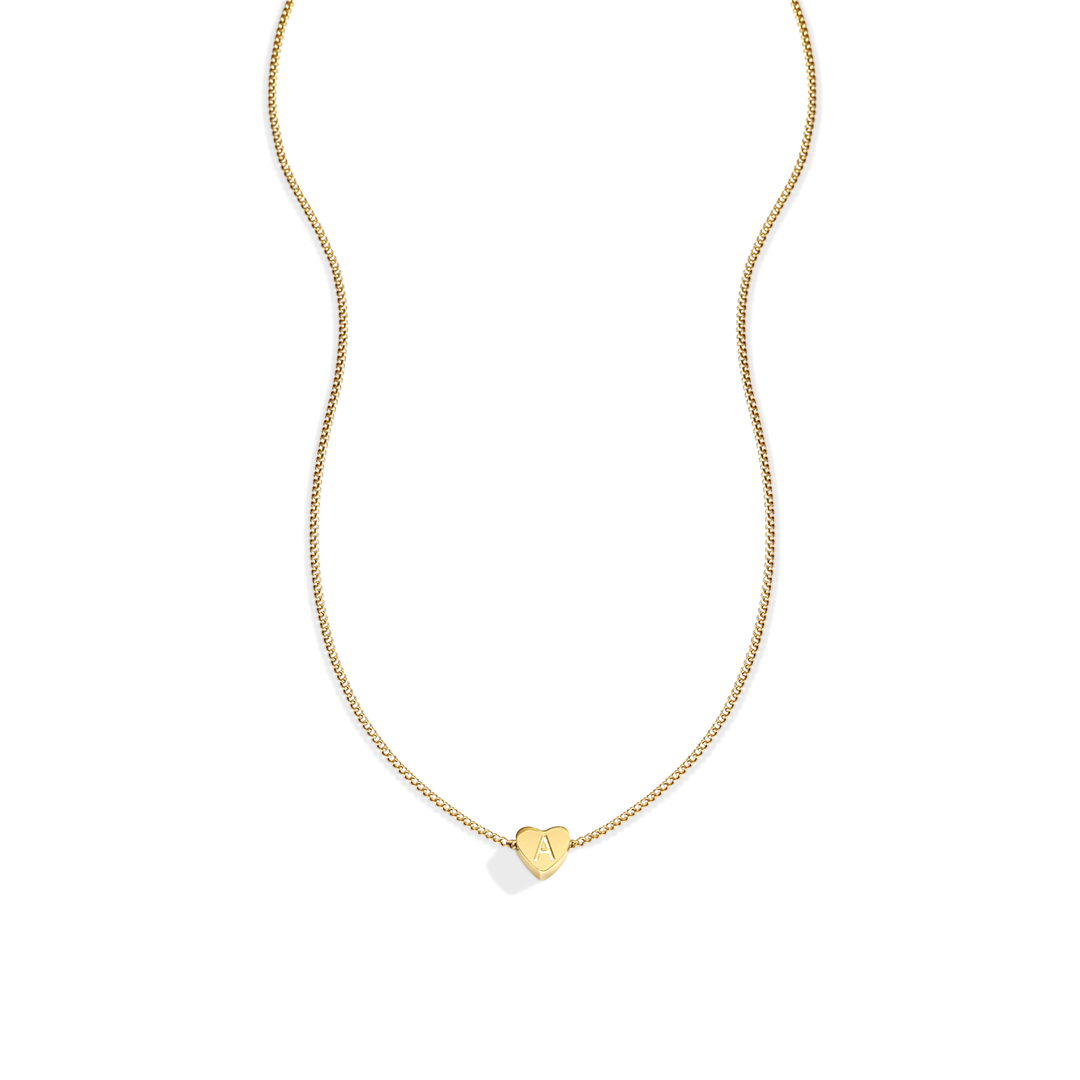 Gold necklace with a heart-shaped pendant on a light gray background