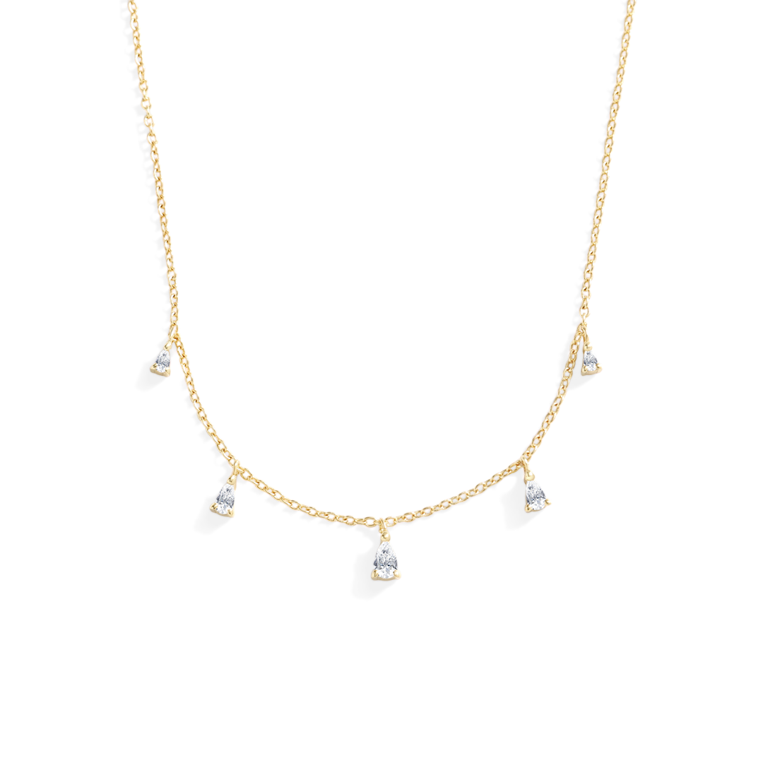 Gold necklace with small pendants on a white background