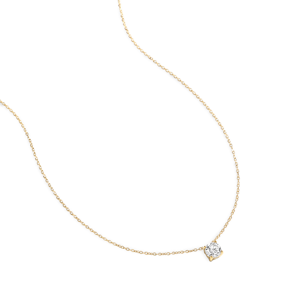 Gold necklace with a diamond pendant on a white background