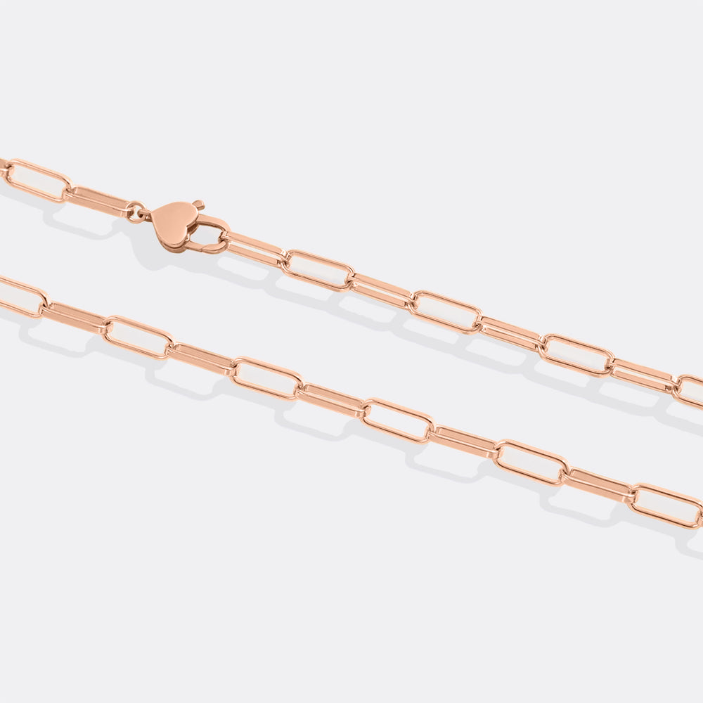 Rose gold chain necklace on a light gray background