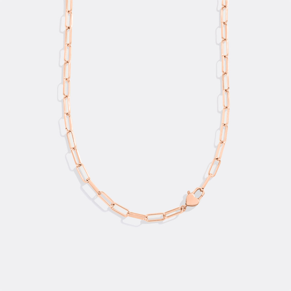 Rose gold chain necklace on a light gray background