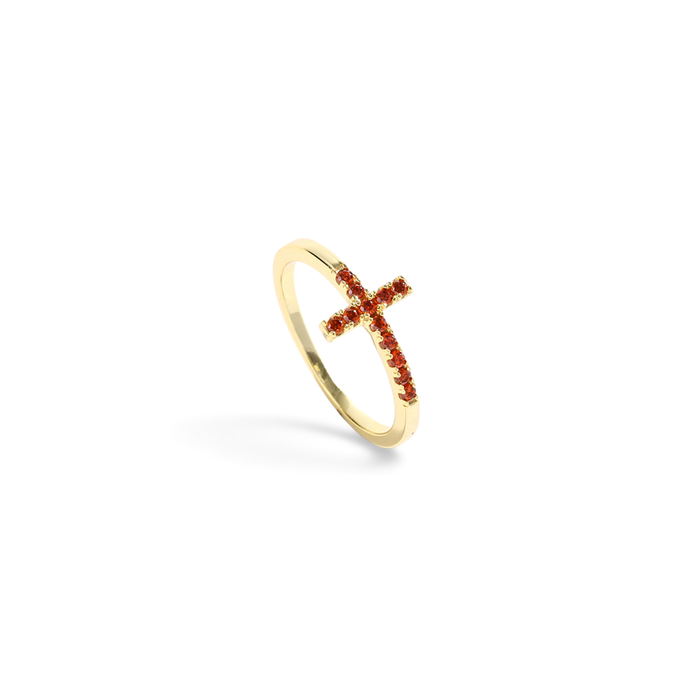 Gold ring with a red gemstone cross on a white background