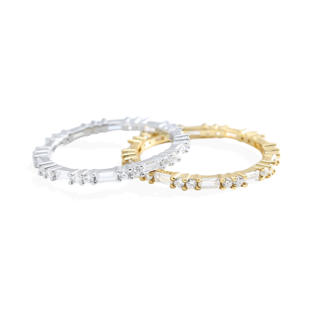 Two gold and silver rings with gemstones on a white background