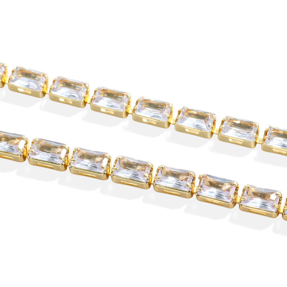 Bracelet with gold and clear gemstones on a light background
