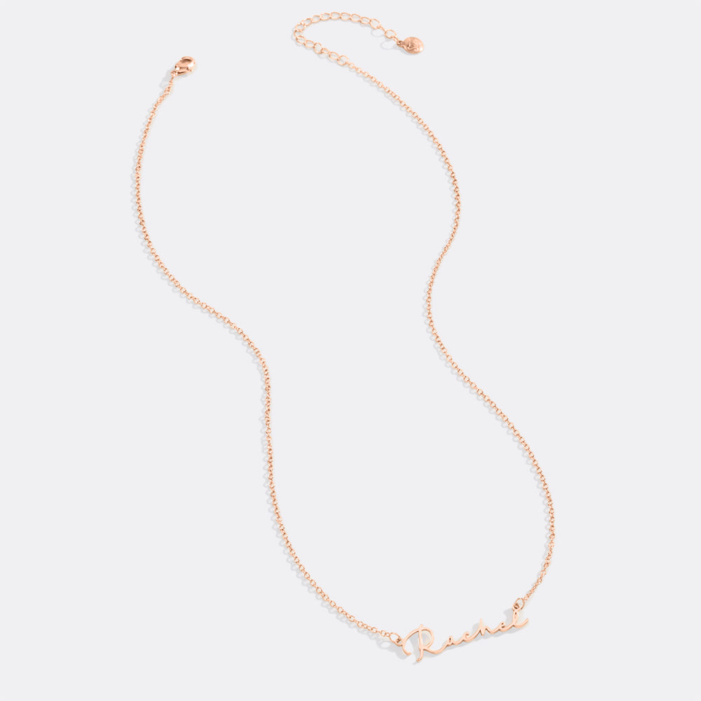Rose gold necklace on a light pink background