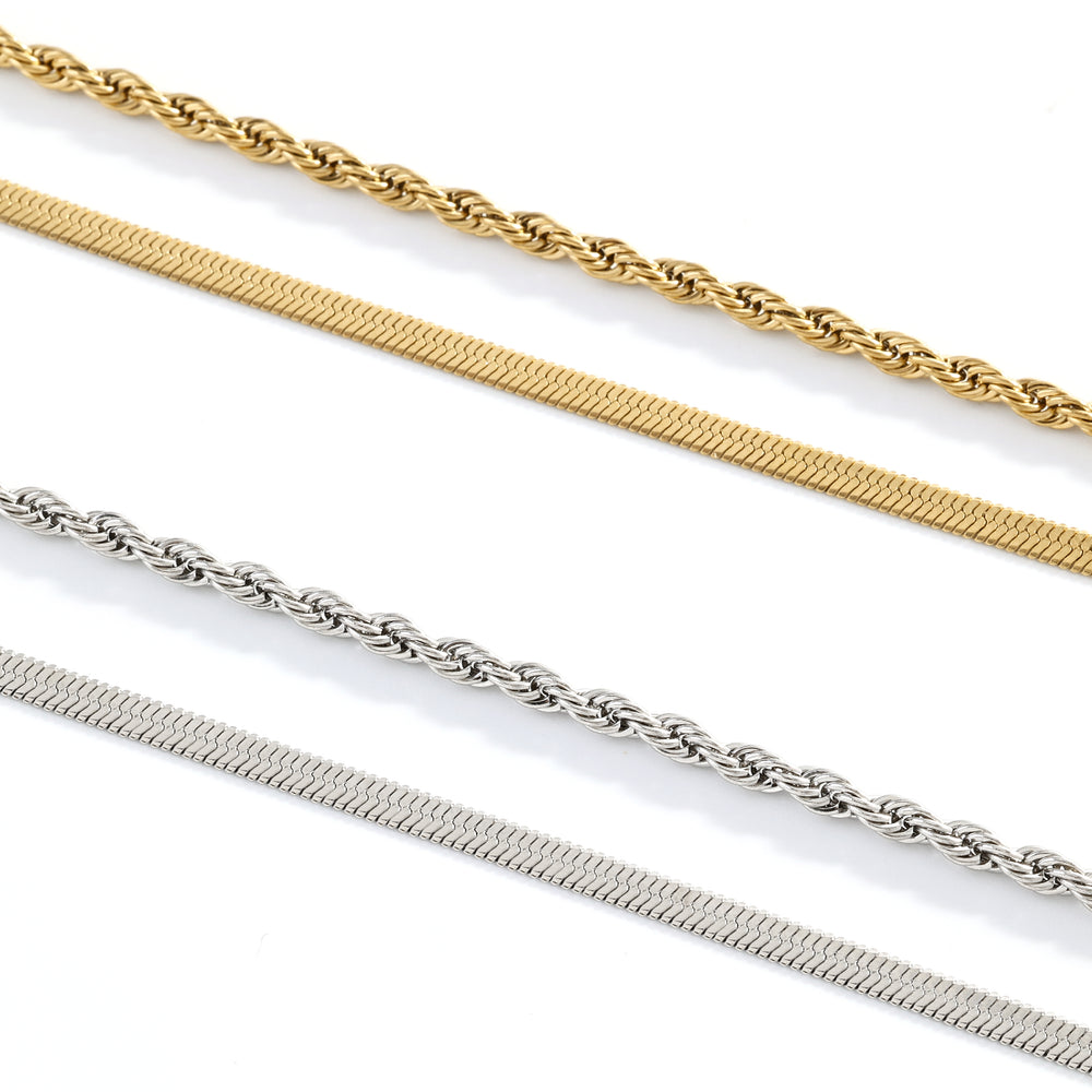 Three gold and silver chains on a white background