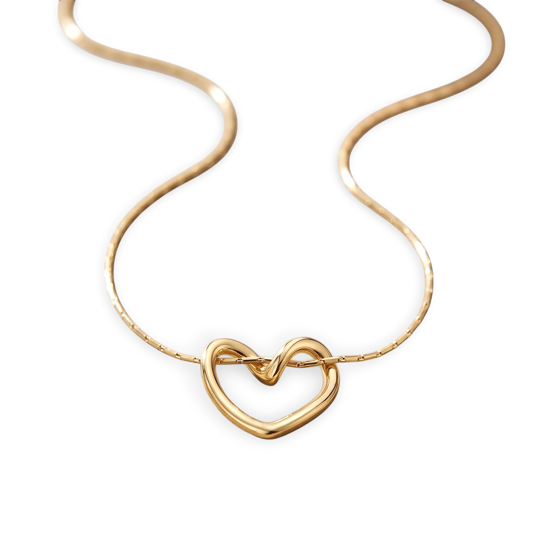 Gold heart-shaped necklace on a light gray background