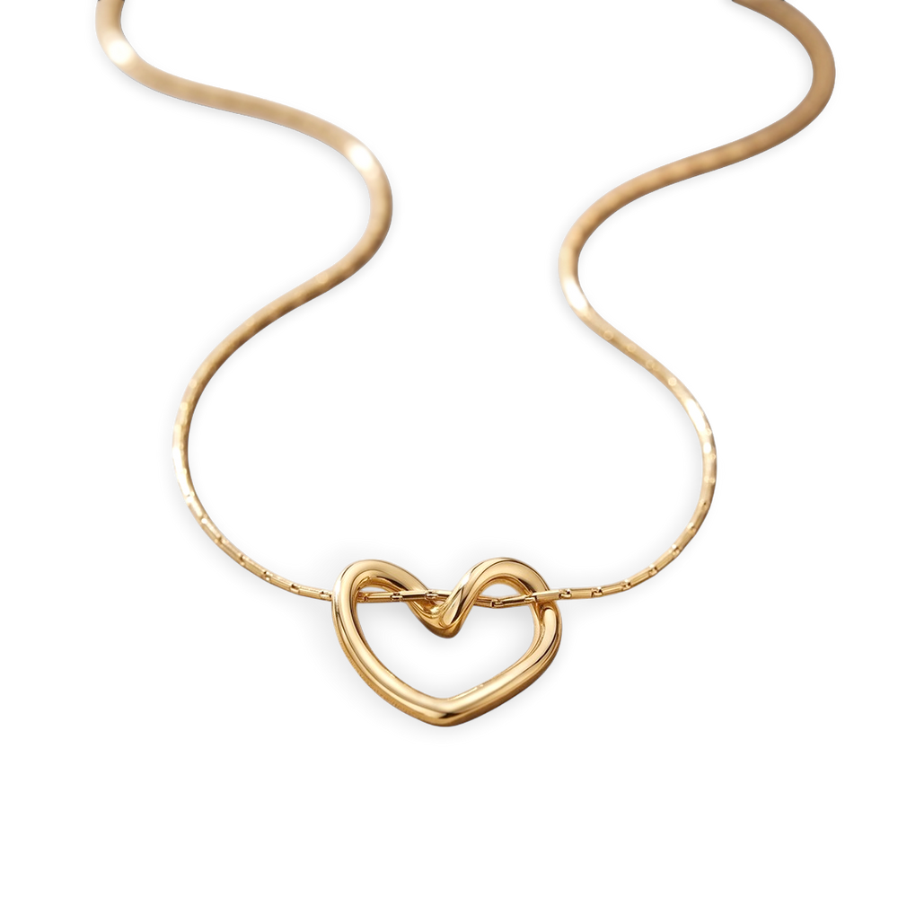 Gold heart-shaped necklace on a light gray background