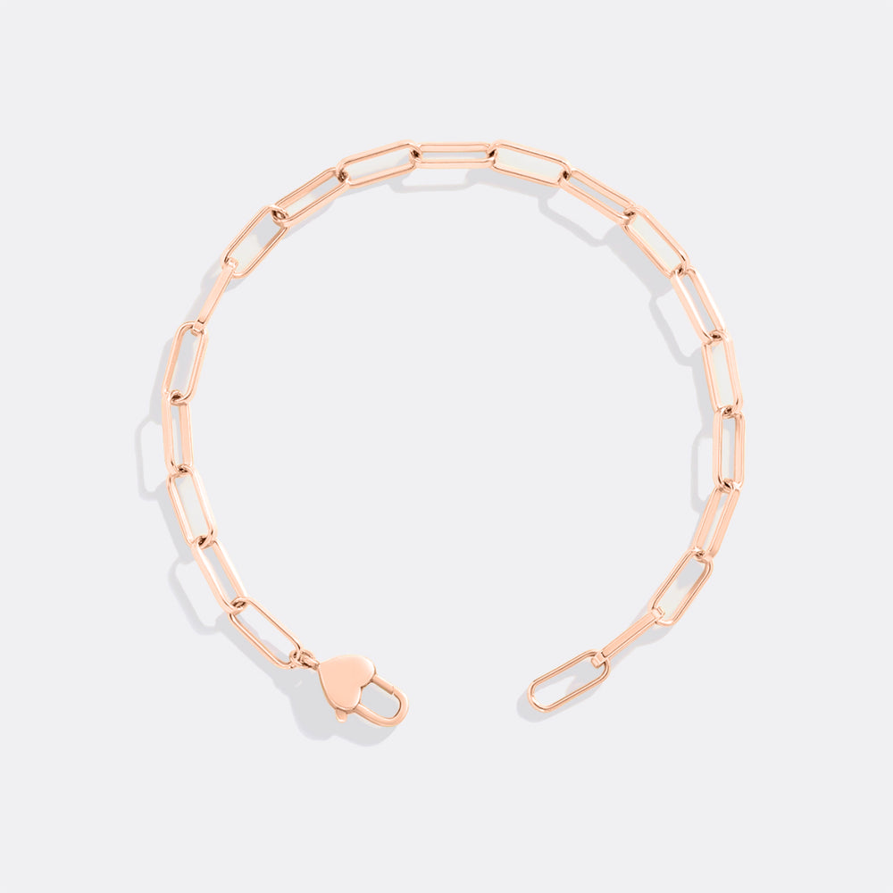 Rose gold chain bracelet on a light gray background