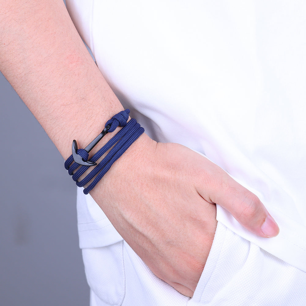 A blue infinity cord bracelet with a marine-inspired hook clasp, displayed on a wrist.