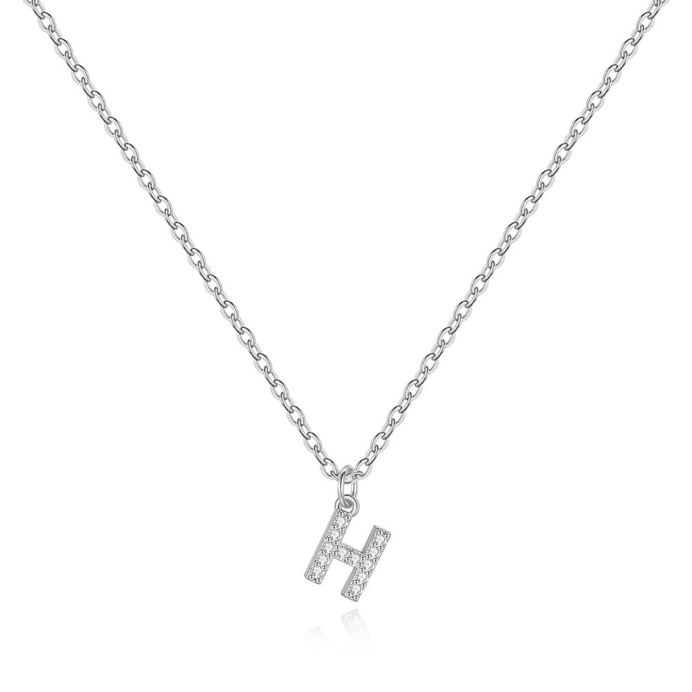 A sterling silver uppercase initial necklace with a dainty cable chain and a pendant featuring cubic zirconia.
