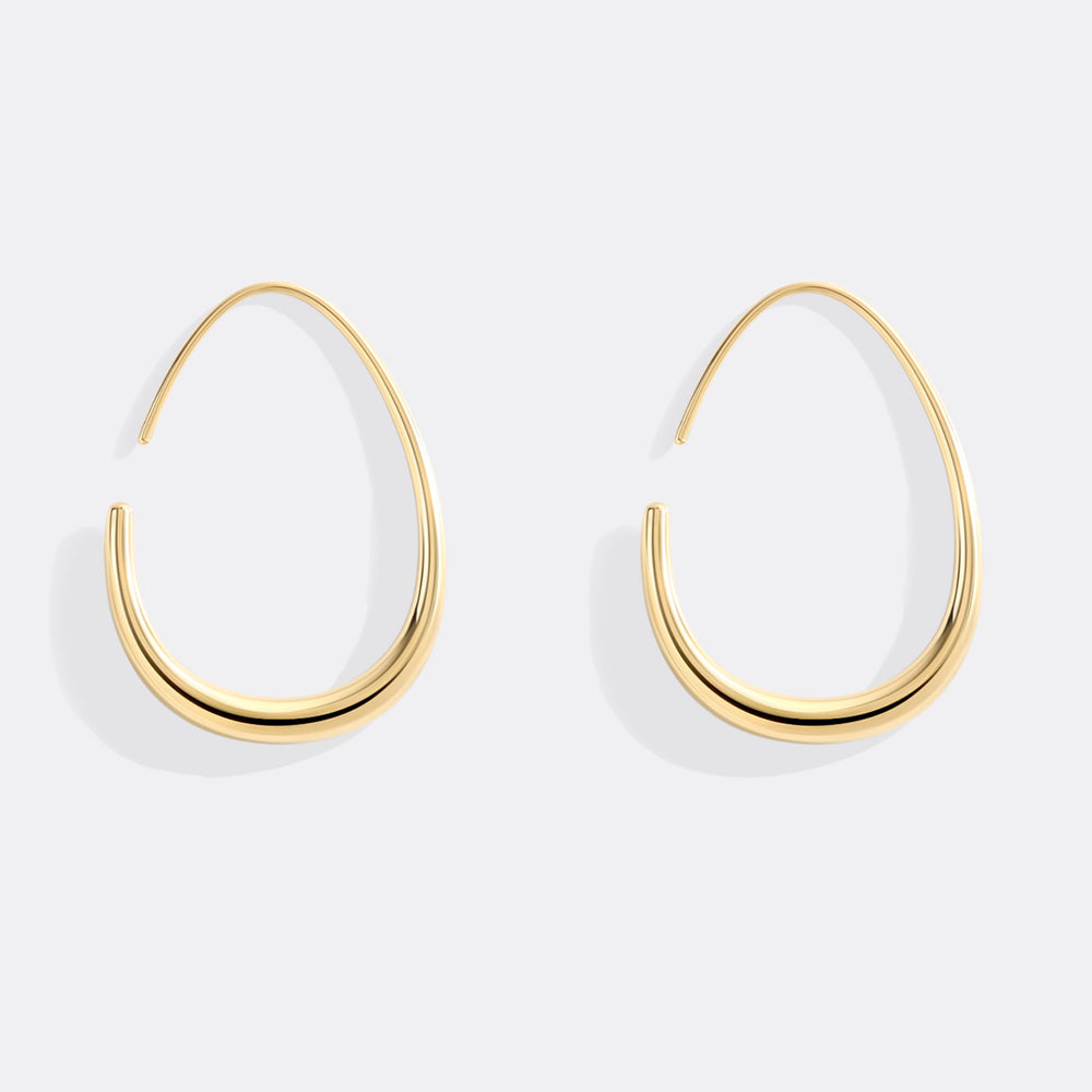 Gold hoop earrings on a white background