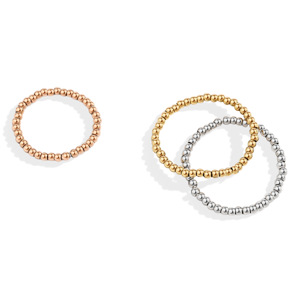 Three beaded rings in rose gold, gold, and silver on a light gray background