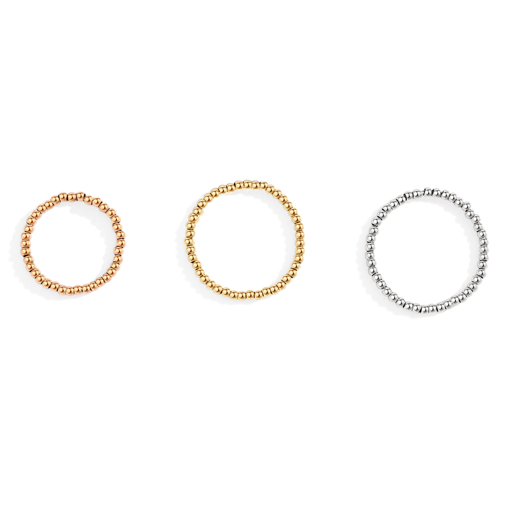 Three beaded rings in gold, silver, and rose gold on a white background