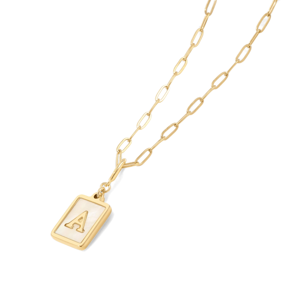 Gold necklace with a pendant on a light gray background