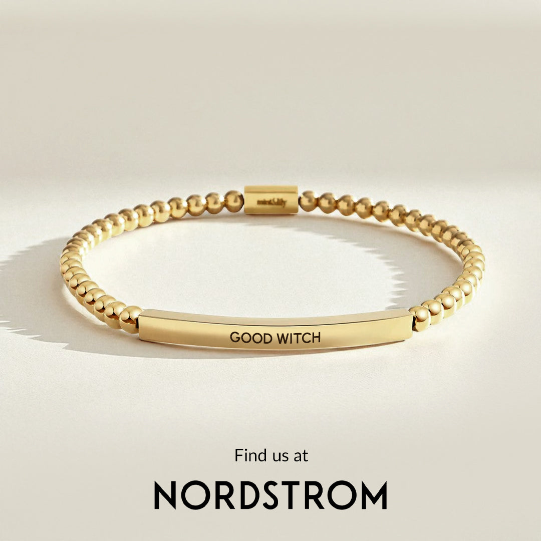 Gold bracelet with 'GOOD WITCH' engraving on a light background, Nordstrom branding visible.