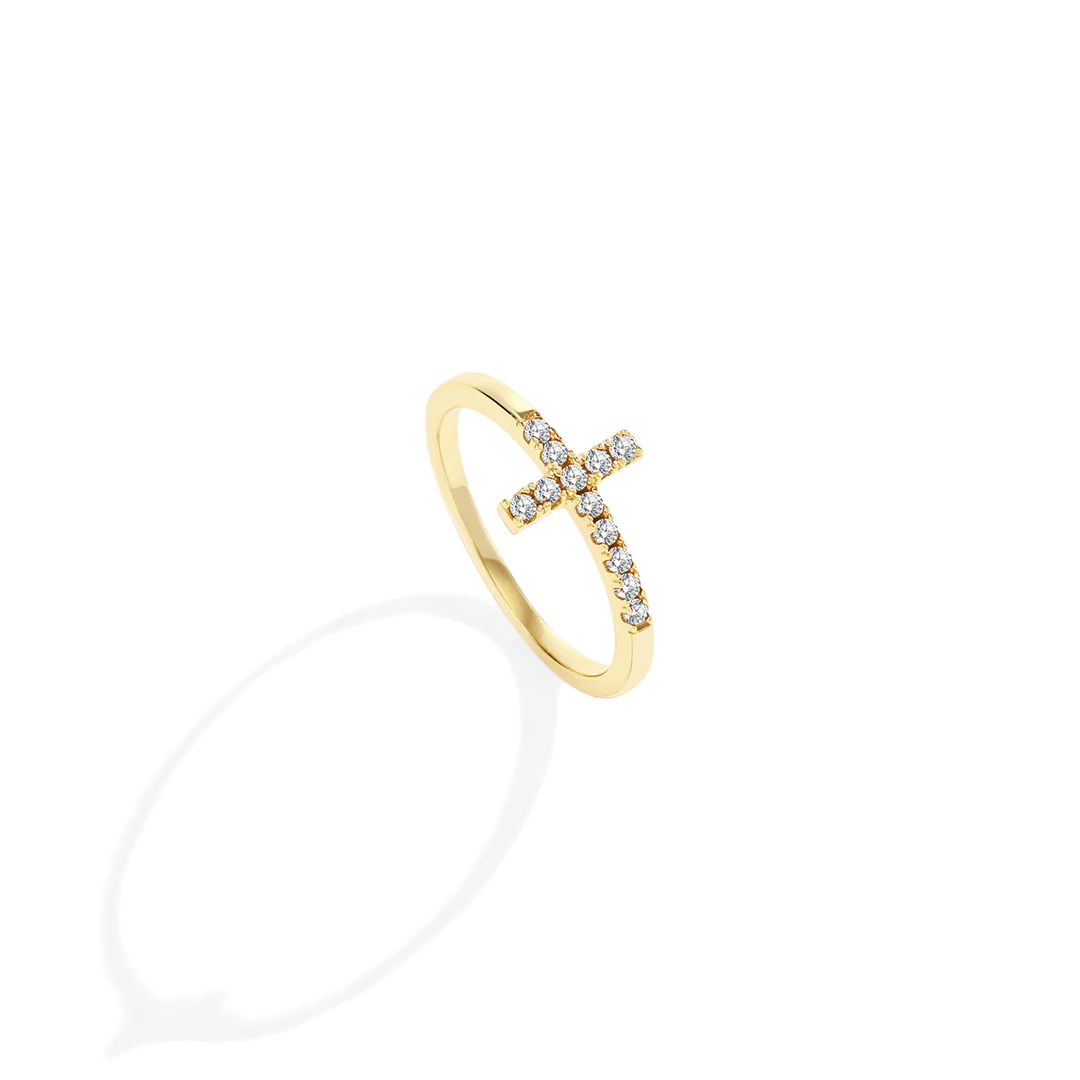 Gold ring with small diamonds on a light gray background