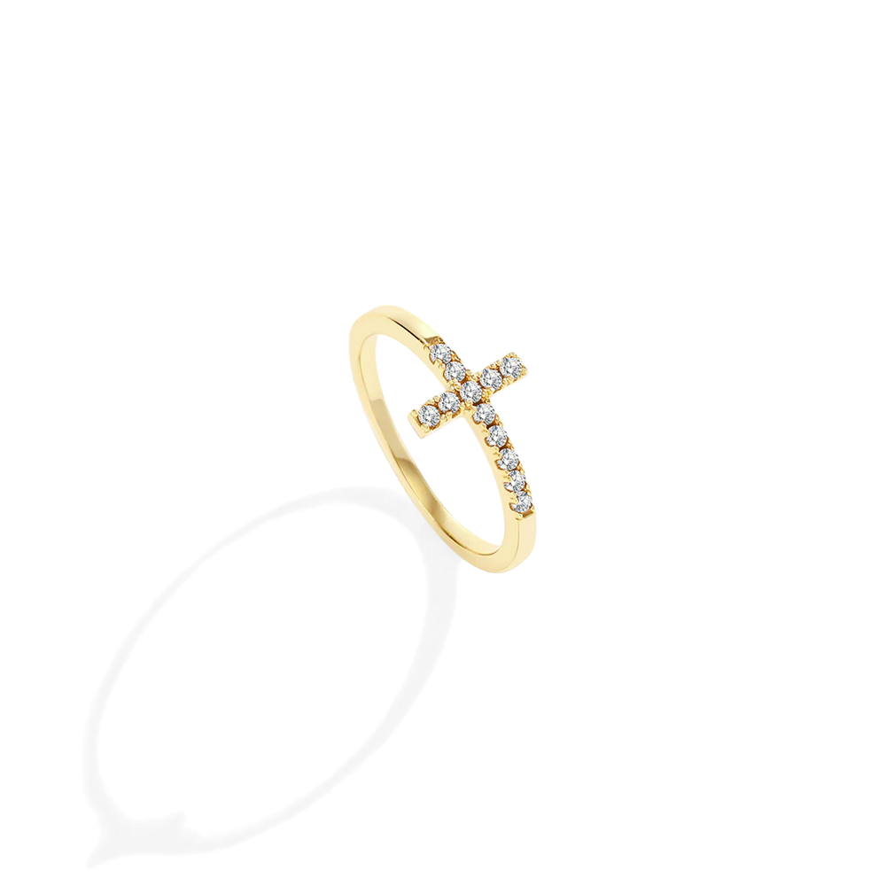 Gold ring with small diamonds on a light gray background