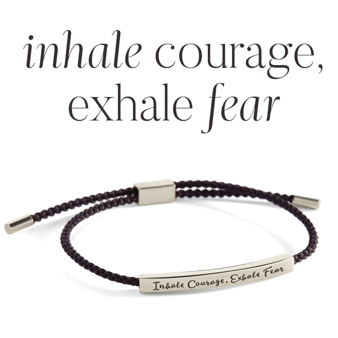 Bracelet with 'Inhale Courage, Exhale Fear' message on a light gray background