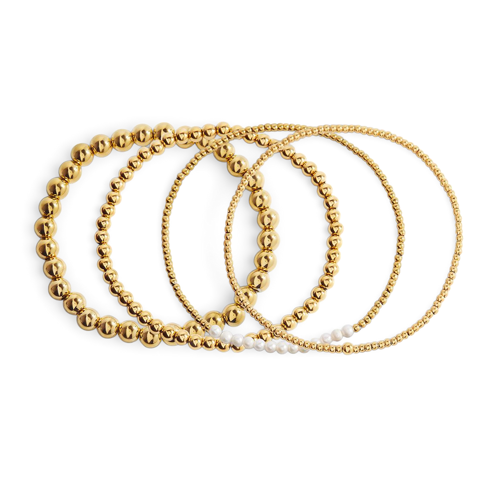 Set of gold beaded bracelets on a white background