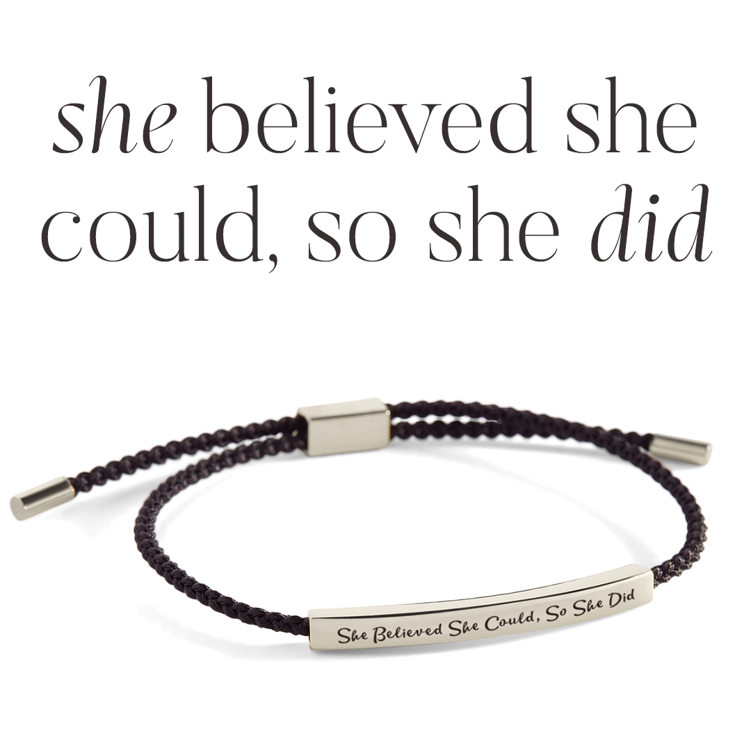 Bracelet with 'She believed she could, so she did' message on a light gray background