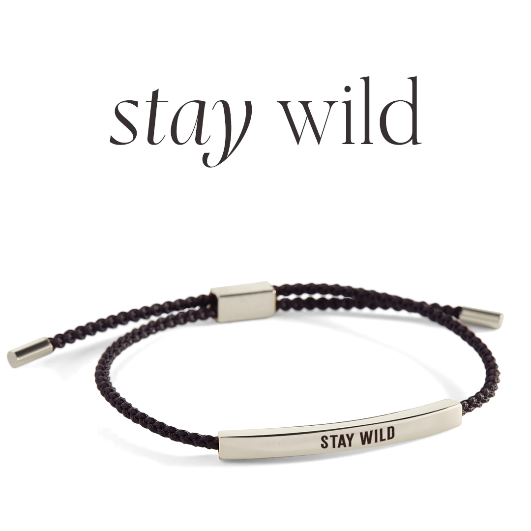 Bracelet with 'stay wild' engraving on a light gray background
