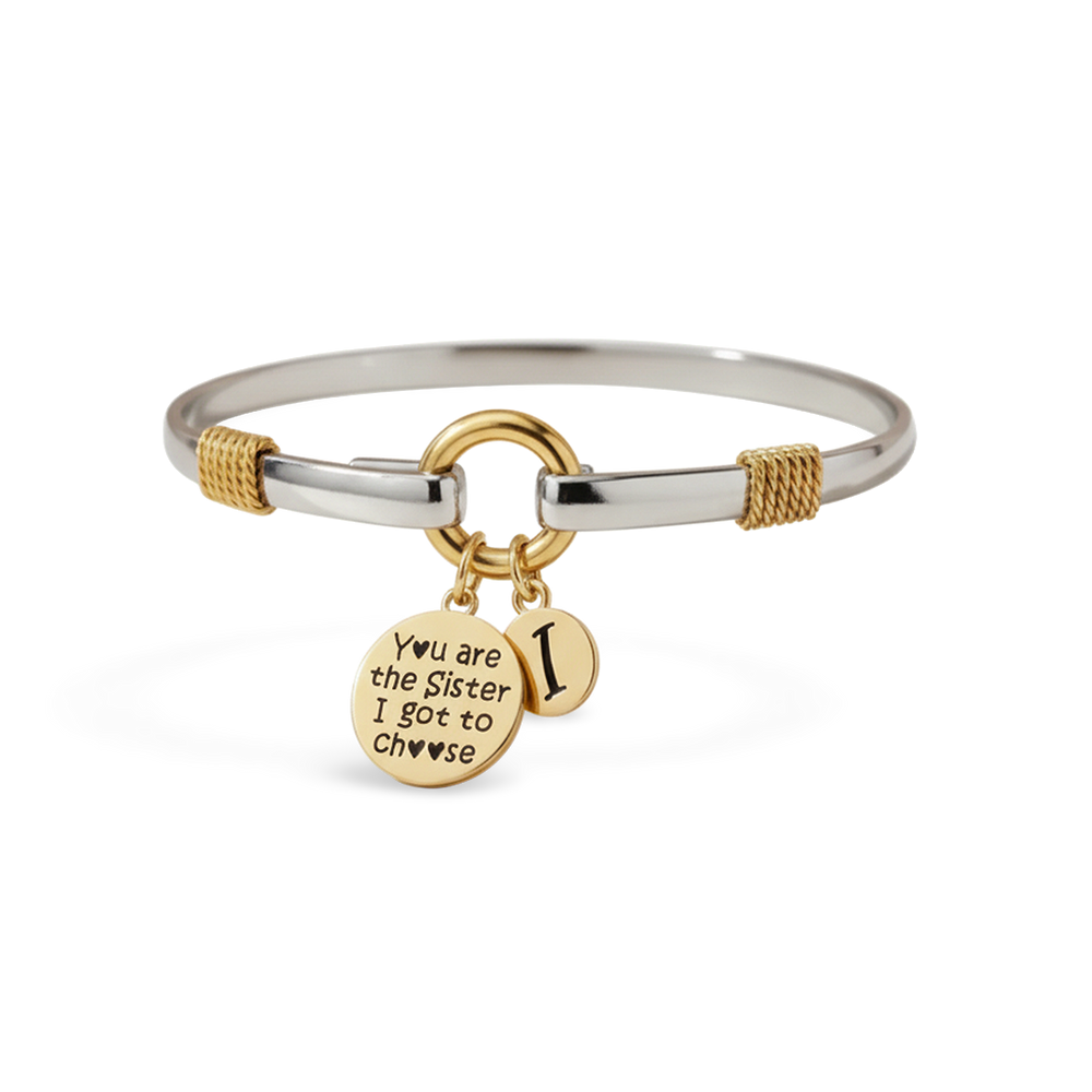 Silver bracelet with gold charm on a white background