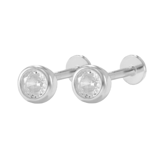 A pair of gold-colored bezel stud flatback earrings with clear stones set in gold-colored metal.